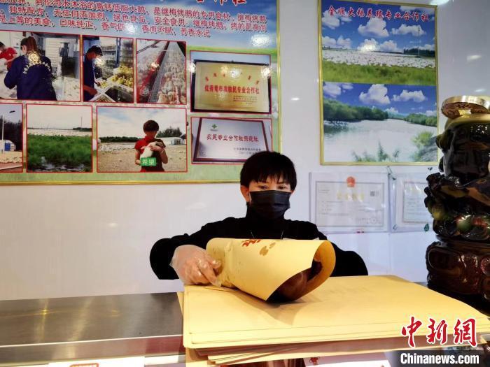 圖為鄭繼梅正在打包烤鵝。　謝宏秀供圖